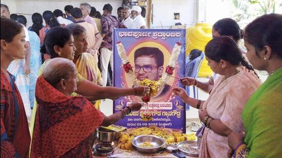 Locals pay floral tribute to Naveen Shekharappa, a final year medical student, who was killed in Russian shelling in the Ukrainian city of Kharkiv, at Chalageri village, in Haveri on Wednesday. (PTI)
