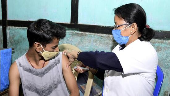 A healthcare worker inoculates a teenager with a dose of COVAXIN against COVID-19 disease during a vaccination drive, at a school, in Nagaon. (ANI)