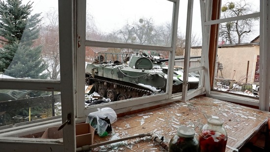 Destroyed armoured vehicles are seen through broken windows of a house in the town of Bucha in the Kyiv region, Ukraine.(REUTERS)