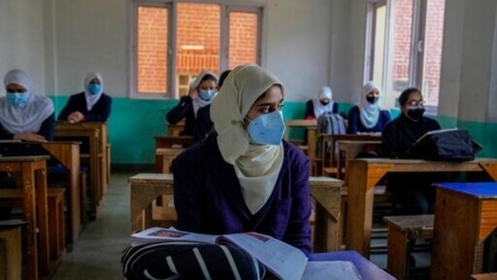 Students of secondary and higher secondary carried their vaccination certificates to show at the entry gates.(AP)