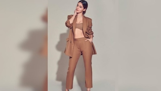 Ananya Panday aced the neutral look as she struck boss lady poses in a crop top, trousers and oversized blazer.(Instagram/@tanyaghavri)