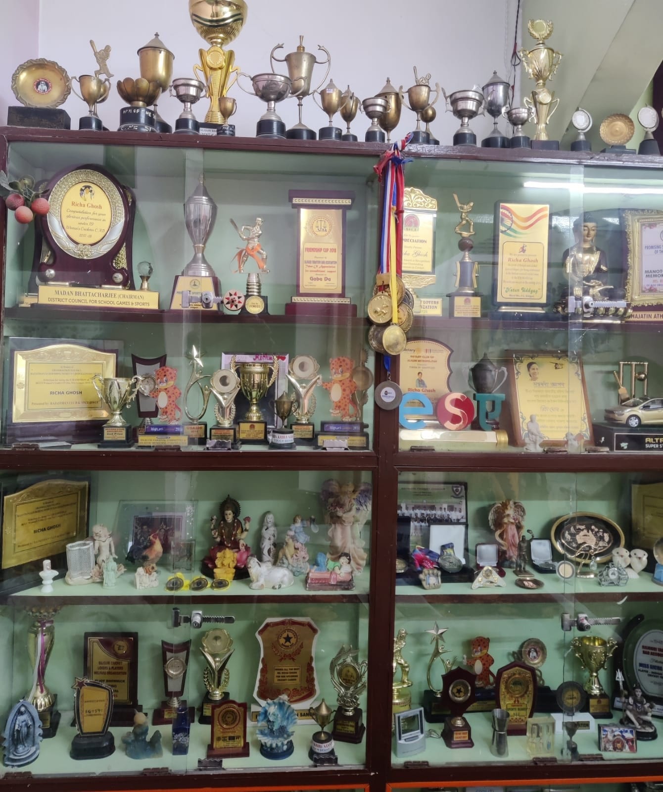 Trophies won by Richa Ghosh kept in a cabinet at her house.(HT Photo/Shivam Saha) Trophies won by Richa Ghosh kept in a cabinet at her house.(HT Photo/Shivam Saha)