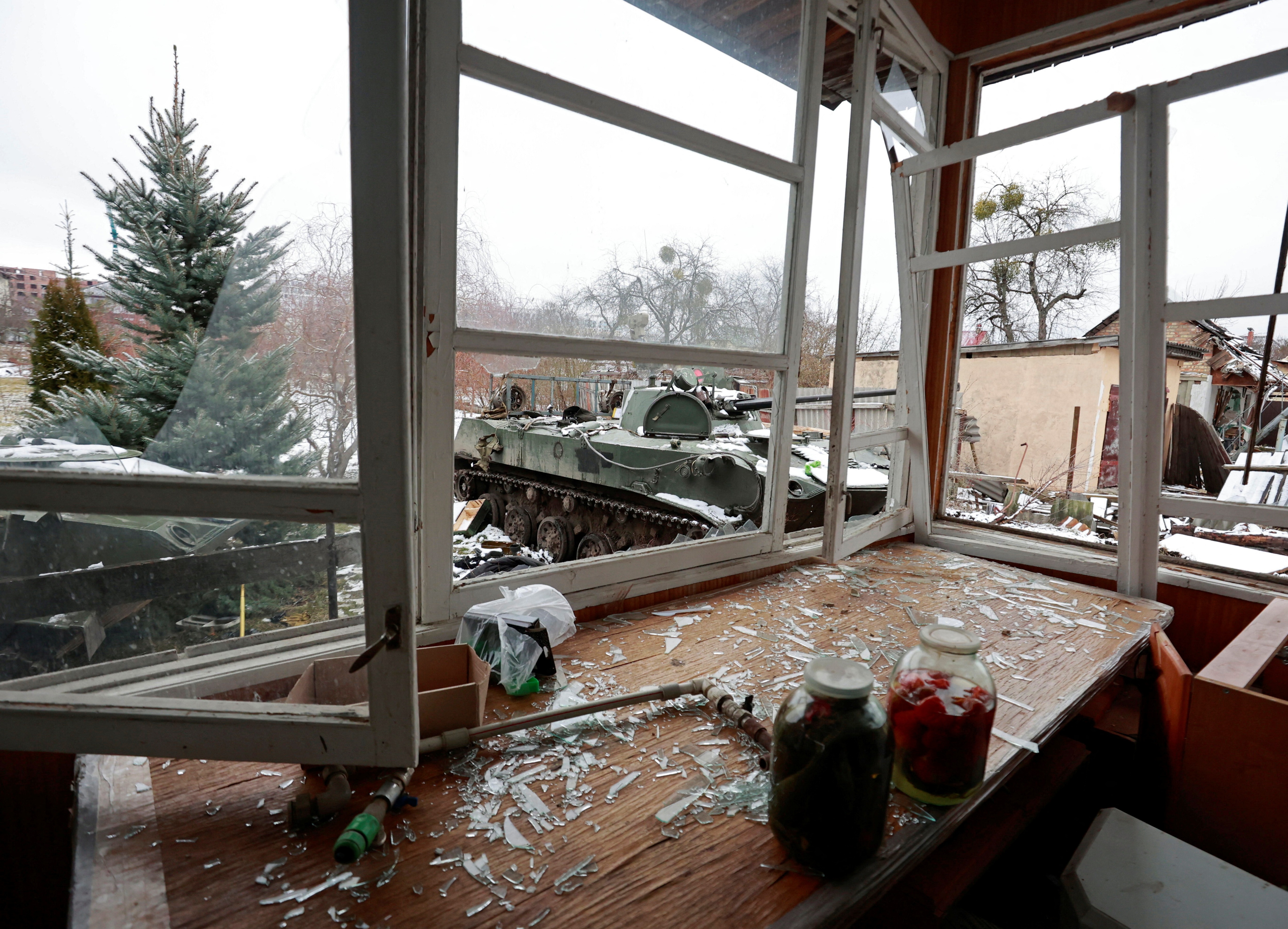 Destroyed armoured vehicles are seen through broken windows of a house in the town of Bucha in the Kyiv region, Ukraine. (REUTERS)