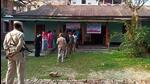 Police personnel stand guard while voters wait to cast their ballot during the first phase of Manipur assembly elections on Monday. (ANI Photo) Police personnel stand guard while voters wait to cast their ballot during the first phase of Manipur assembly elections on Monday. (ANI Photo)