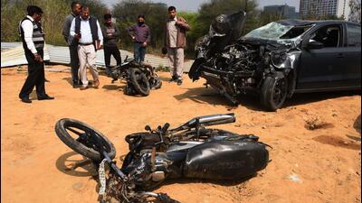 Policemen inspect the mangled remains of two motorcycles and a car at the accident site on Golf Course Road, in Gurugram on Thursday. (Vipin Kumar/HT PHOTO) Policemen inspect the mangled remains of two motorcycles and a car at the accident site on Golf Course Road, in Gurugram on Thursday. (Vipin Kumar/HT PHOTO)