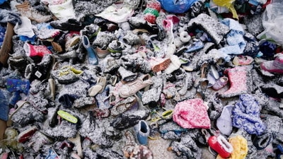 Piles of clothing lined the potholed road as people sought to lighten their load. (REUTERS)