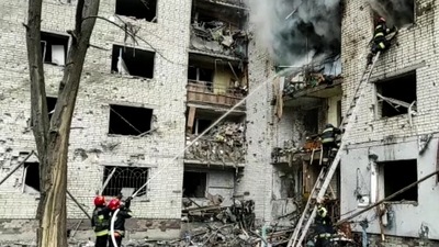 This grab made from a handout video released by the State Emergency Service of Ukraine, shows a damaged apartment building which is said was hit by shelling in Chernihiv. (AFP)