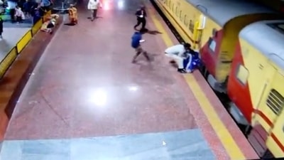 Railway Police Officer catching passenger before she slips under the tracks Railway Police Officer catching passenger before she slips under the tracks
