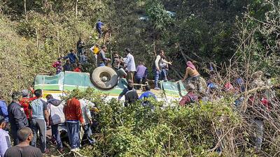 Locals during a rescue operation as a HRTC bus falls down into a gorge at Sarkaghat, in Mandi, on Thursday. (PTI)
