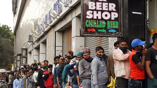 People stand in a queue outside a liquor store in Delhi. (ANI Photo)