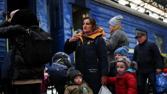 A family fleeing Russian invasion of Ukraine arrives at a train station in Lviv, Ukraine.(Reuters photo)