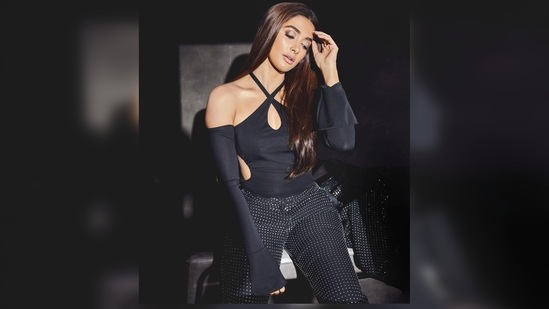 In another photo, Pooja Hegde kept her blazer aside and posed in her cut-out halter top and pants.(Instagram/@hegdepooja)