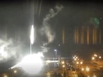 This image made from a video released by Zaporizhzhia nuclear power plant shows bright flaring objects landing in grounds of the nuclear plant in Enerhodar, Ukraine. This image made from a video released by Zaporizhzhia nuclear power plant shows bright flaring objects landing in grounds of the nuclear plant in Enerhodar, Ukraine.