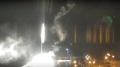 This image made from a video released by Zaporizhzhia nuclear power plant shows bright flaring objects landing in grounds of the nuclear plant in Enerhodar, Ukraine. (AP)