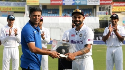 Team India head coach Rahul Dravid presents Virat Kohli with his 100th baggy blue to commemorate his 100th appearance in whites. (#BCCI) Team India head coach Rahul Dravid presents Virat Kohli with his 100th baggy blue to commemorate his 100th appearance in whites. (#BCCI)