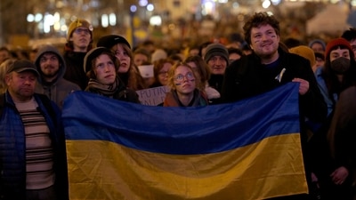 Demonstrators stand in front of screens broadcasting live speech of Ukraine's President Volodymyr Zelenskiy, in Prague. (REUTERS)