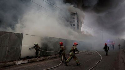Firefighters extinguish fire at a warehouse that caught flames, according to local authorities, after shelling, as Russia's invasion of Ukraine continues, in the village of Chaiky in the Kyiv region. (Reuters)