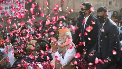 Prime Minister Narendra Modi greets supporters during a roadshow for the seventh and last phase of UP Assembly elections, in Varanasi, Friday,&nbsp; (PTI)