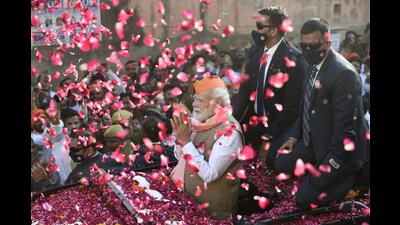 •Prime Minister Narendra Modi greets supporters during a roadshow for the seventh and last phase of UP Assembly elections, in Varanasi, Friday, (PTI Photo) •Prime Minister Narendra Modi greets supporters during a roadshow for the seventh and last phase of UP Assembly elections, in Varanasi, Friday, (PTI Photo)