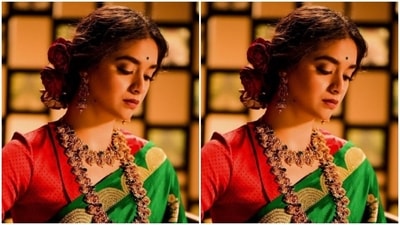 Keerthy paired a contrasting red blouse with sweetheart neckline with the saree. Keerthy's saree came embroidered in golden zari and floral patterns throughout the length. (Instagram/@keerthysureshofficial)
