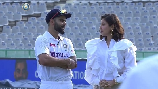 Virat Kohli and Anushka Sharma on the field in Mohali on Friday.&nbsp;