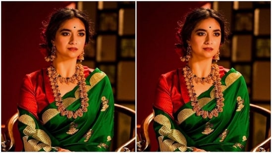 Styled by fashion stylist Archa Mehta, Keerthy wore her tresses into a bun with a middle part and decorated her hairdo with red roses. In nude eyeshadow, black eyeliner, mascara-laden eyelashes, drawn eyebrows, contoured cheeks, red lipstick and a small black bindi, Keerthy looked stunning.(Instagram/@keerthysureshofficial)