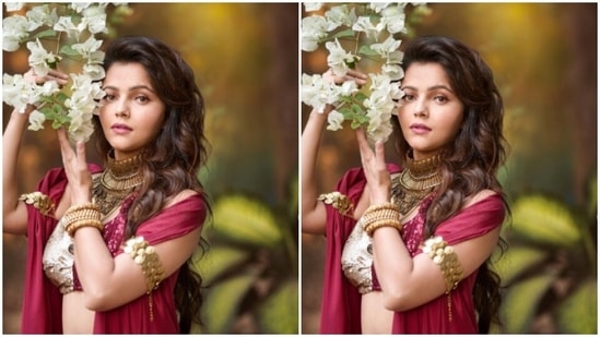 Styled by fashion stylist Anuradha Khurana, Rubina wore her tresses open in wavy curls with a side part as she posed with a branch of white bougainvillea.(Instagram/@rubinadilaik)