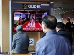 People watch a TV broadcasting file footage of a news report on North Korea firing a ballistic missile off its east coast, in Seoul, South Korea.