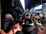 TOPSHOT - People try to get an evacuation train at Kyiv central train station. (Photo by Sergei CHUZAVKOV / AFP)(AFP) TOPSHOT - People try to get an evacuation train at Kyiv central train station. (Photo by Sergei CHUZAVKOV / AFP)(AFP)