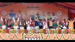 Prime Minister Narendra Modi waves to the supporters during a public meeting for the seventh and last phase of Uttar Pradesh Assembly elections, as Deputy Chief Minister Swatantra Dev Singh and Union Minister Anupriya Patel look on, at Khajuri village, in Varanasi on Saturday. (ANI Photo)
