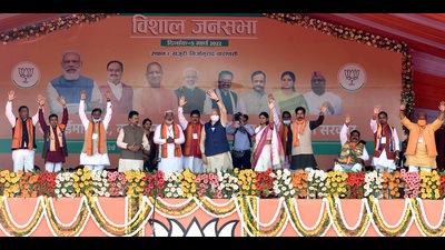 Prime Minister Narendra Modi waves to the supporters during a public meeting for the seventh and last phase of Uttar Pradesh Assembly elections, as Deputy Chief Minister Swatantra Dev Singh and Union Minister Anupriya Patel look on, at Khajuri village, in Varanasi on Saturday. (ANI Photo)