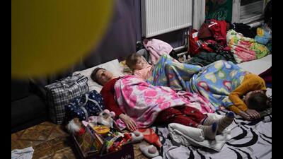 A family rests inside a shelter for refugees at the Lviv Regional Academic Puppet Theatre in western Ukraine on March 5, 2022. - US Secretary of State Antony Blinken met Ukraine Foreign Minister Dmytro Kuleba on the Poland-Ukraine border on March 5, 2022, in a show of solidarity on day 10 of Russia’s invasion of its pro-Western neighbour. (AFP) A family rests inside a shelter for refugees at the Lviv Regional Academic Puppet Theatre in western Ukraine on March 5, 2022. - US Secretary of State Antony Blinken met Ukraine Foreign Minister Dmytro Kuleba on the Poland-Ukraine border on March 5, 2022, in a show of solidarity on day 10 of Russia’s invasion of its pro-Western neighbour. (AFP)