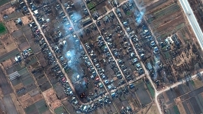 An undated satellite image provided by Maxar Technologies shows a closer view of burning homes and impact craters in a field in Rivnopillya, Ukraine. (AP)