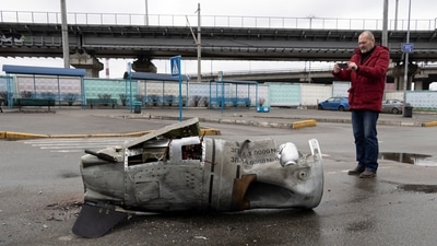 Kyiv: A man takes a photo of the remains of a missile in a street in Vydubychi district of Kyiv, Ukraine. (AP)