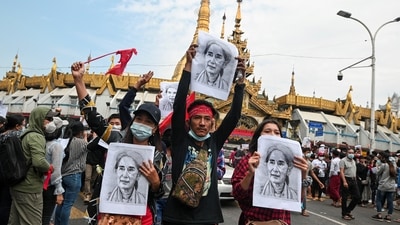 People hold placards depicting leader Aung San Suu Kyi during a rally to demand her release and protest against the military coup, in Yangon, Myanmar. (REUTERS)