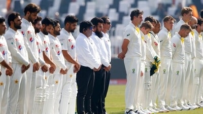 Umpires and players observe a minute's silence. (AP) Umpires and players observe a minute's silence. (AP)
