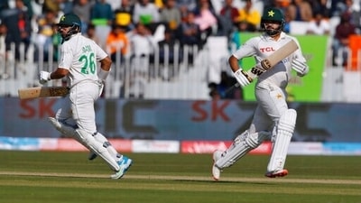 Pakistan's Imam-ul-Haq, left, and Azhar Ali run between the wickets during the 1st day of first Test between Pakistan and Australia. (AP)