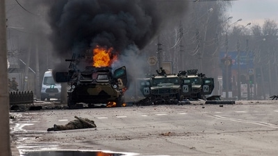 A Russian armored personnel carrier burns amid damaged and abandoned light utility vehicles after fighting in Kharkiv, Ukraine. (AP) A Russian armored personnel carrier burns amid damaged and abandoned light utility vehicles after fighting in Kharkiv, Ukraine. (AP)