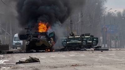 A Russian armored personnel carrier burns amid damaged and abandoned light utility vehicles after fighting in Kharkiv, Ukraine. (AP) A Russian armored personnel carrier burns amid damaged and abandoned light utility vehicles after fighting in Kharkiv, Ukraine. (AP)