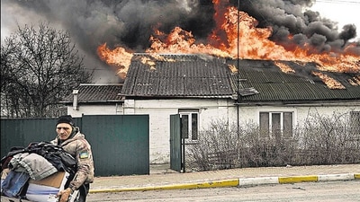 A man removes personal belongings from a house after being shelled in Irpin, outside Kyiv. (AFP)