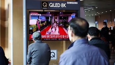 People watch a TV broadcasting file footage of a news report on North Korea firing a ballistic missile off its east coast, in Seoul, South Korea. (REUTERS)