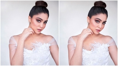 Sharvari's dress comes in a bodycon silhouette accentuating her svelte frame. The ensemble features a mini hem length, off-shoulder neckline, feather adornments, and white sequins, pearls and beads embellished in various spring-inspired patterns. (Instagram/@sharvari)
