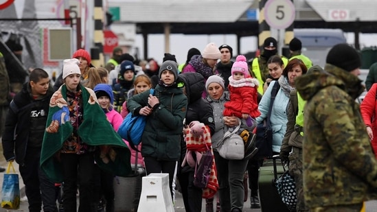 People coming from Ukraine, cross the Ukrainian-Polish border in Korczowa, Poland on Saturday.(AFP)