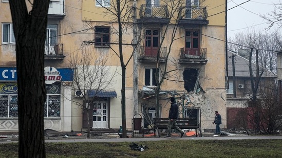 A man walks past an apartment building hit by shelling in Mariupol, Ukraine.(AP) A man walks past an apartment building hit by shelling in Mariupol, Ukraine.