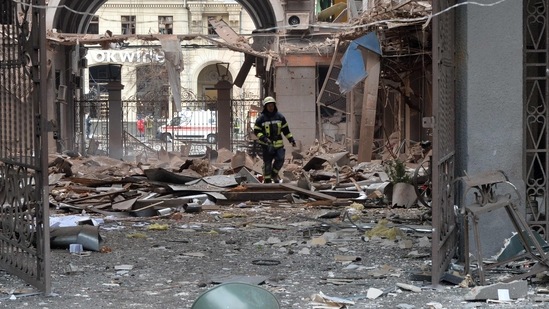 A firefighter walks through a damaged building entrance in Kharkiv, Ukraine.