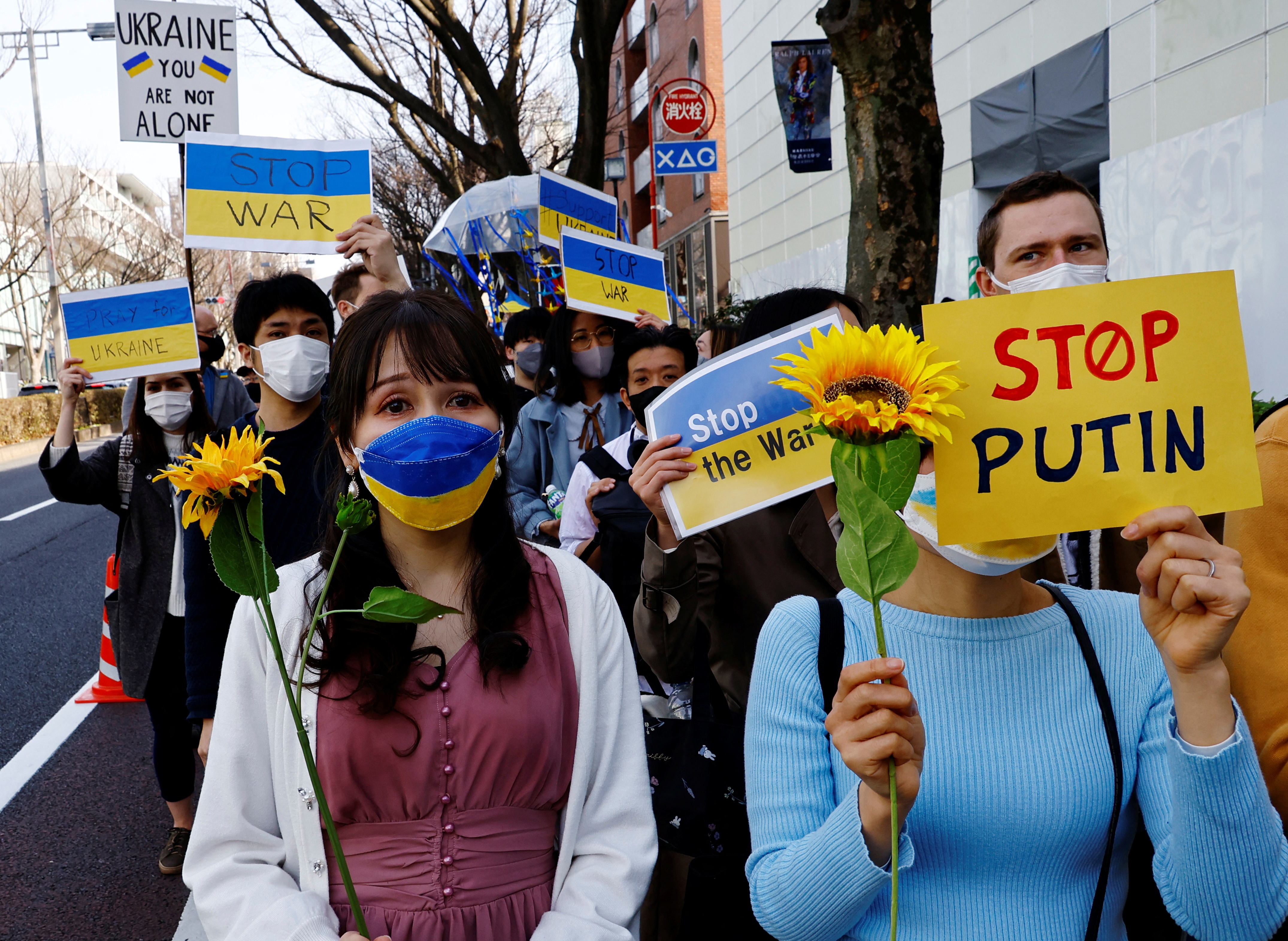 Protesters wearing protective masks, amid the coronavirus disease (Covid-19) outbreak, participate in a march to protest against Russia's invasion of Ukraine, in Tokyo, Japan. (REUTERS)