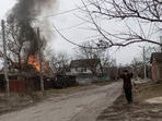 A local resident reacts as a house is on fire after heavy shelling on the only escape route used by locals to leave the town of Irpin, while Russian troops advance toward the capital, 24km from Kyiv, Ukraine.(REUTERS)