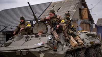Kyiv: Ukrainian soldiers drive on an armored military vehicle in the outskirts of Kyiv,&nbsp; (AP)