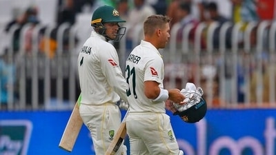 Australia's Usman Khawaja, left, and David Warner walks back to pavilion on the end of the second day of play of the first cricket test match between Pakistan and Australia at the Pindi Stadium (AP)