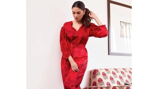 It was tucked inside a pair of matching cherry red trousers that sported scratch print and came with a drawstring waist. Aditi completed her attire with a pair of red heels.&nbsp;(Instagram/sanamratansi)
